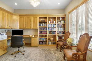 Carpeted home office featuring a notable chandelier and recessed lighting