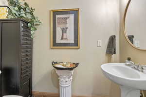 Bathroom with baseboards and a sink