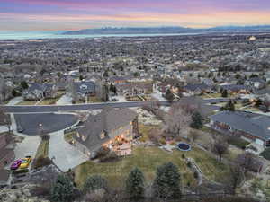 Aerial view at dusk featuring a mountain view and a residential view