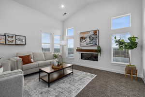 Living room featuring vaulted ceilings and cozy fireplace