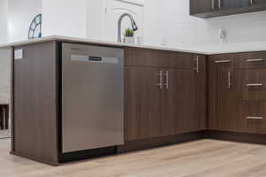 Elevated kitchen finishes include quartz counters, tile backsplash, and stainless steel appliances
