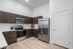 Elevated kitchen finishes include quartz counters, tile backsplash, and stainless steel appliances
