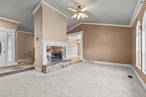 Unfurnished living room featuring visible vents, carpet, ceiling fan, and vaulted ceiling