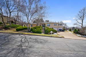 View of front of property with stucco siding, a garage, stairway, and concrete driveway