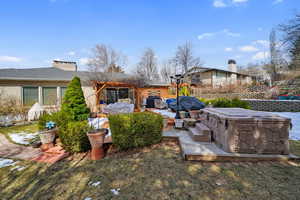 View of yard with a hot tub, fence, and a patio area