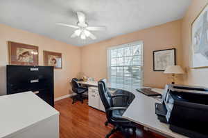 Home office featuring baseboards, ceiling fan, and wood finished floors