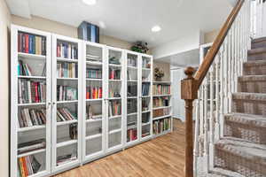 Living area featuring wood finished floors and stairway