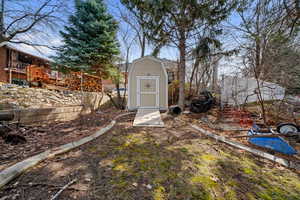 View of yard featuring an outdoor structure and a shed