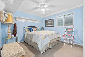 Carpeted bedroom featuring baseboards and ceiling fan