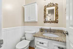 Bathroom with wainscoting and vanity