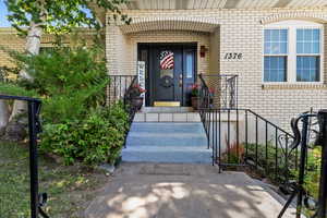 Entrance to property featuring brick siding
