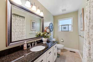 Full bathroom featuring visible vents, tile patterned floors, toilet, and vanity