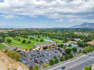 Drone / aerial view featuring golf course view and a water and mountain view