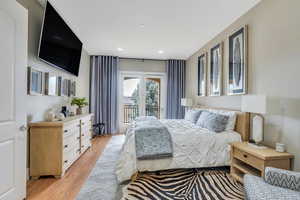 Bedroom featuring light wood-style floors, access to outside, and recessed lighting