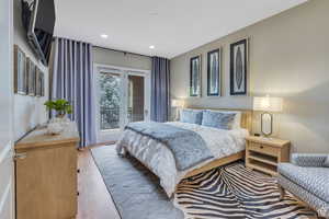 Bedroom featuring recessed lighting, access to outside, and wood finished floors