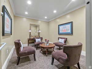 Living room with baseboards, carpet, crown molding, and recessed lighting