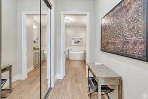 Corridor featuring baseboards and wood finished floors