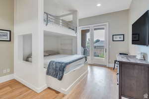 Bedroom featuring baseboards, access to outside, recessed lighting, and light wood finished floors