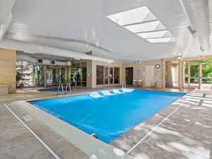 Community pool featuring a skylight