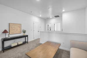 Office with recessed lighting, carpet floors, baseboards, and visible vents