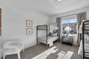 Bedroom featuring baseboards and carpet