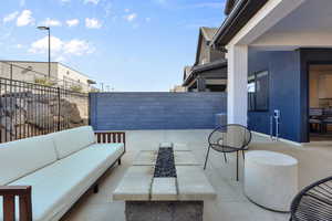 View of patio with a fenced backyard and an outdoor living space with a fire pit