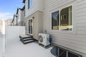 View of patio / terrace with ac unit, fence, and a mountain view