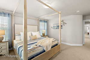 Carpeted bedroom featuring baseboards