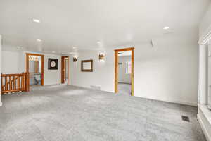 Unfurnished room featuring visible vents, recessed lighting, and light carpet