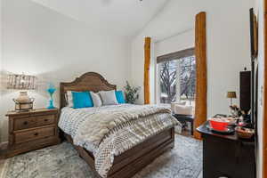 Bedroom featuring vaulted ceiling and wood finished floors