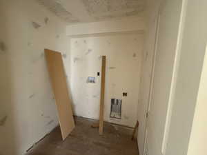 Washroom with washer hookup, heating unit, and laundry area
