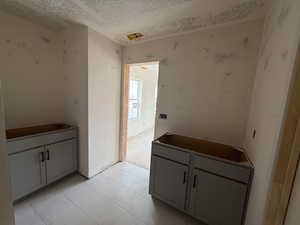 Interior space featuring marble finish floor and a textured ceiling