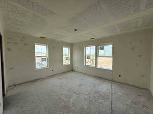 Spare room with a healthy amount of sunlight