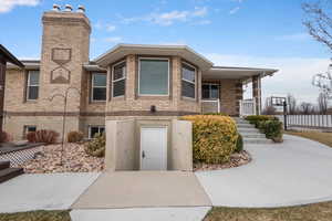Multi unit property featuring covered porch and brick siding