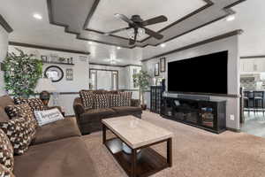 Living room featuring ceiling fan, recessed lighting, crown molding, and a raised ceiling