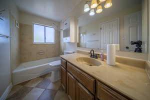 Full bathroom featuring visible vents, shower / washtub combination, vanity, toilet, and an inviting chandelier
