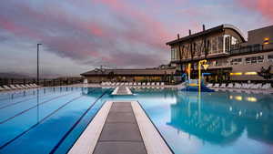 Community pool with a patio area and fence