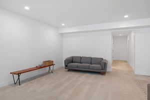 Sitting room featuring recessed lighting, light colored carpet, and baseboards