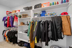 Walk in closet featuring carpet flooring