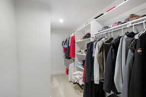 Walk in closet with light carpet