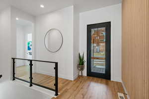 Entryway featuring recessed lighting, visible vents, baseboards, and wood finished floors
