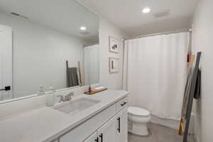Full bathroom featuring visible vents, recessed lighting, toilet, and vanity