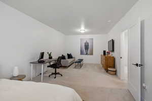 Bedroom featuring baseboards and light carpet