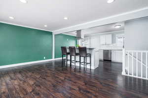 Living room on the main level facing kitchen island in an open floor plan.