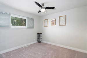 Carpeted bedroom with baseboards, a textured ceiling, ceiling fan, and visible vents