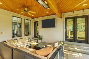 View of patio with entry steps, outdoor lounge area, and ceiling fan