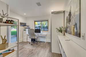 Office area featuring baseboards, recessed lighting, and light wood-type flooring