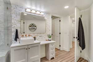 Bathroom with visible vents, wood finished floors, and vanity