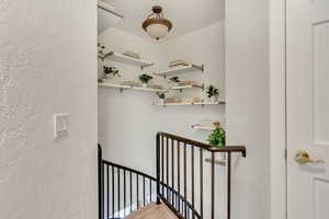 Stairway featuring a textured wall