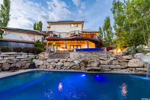 Outdoor pool with an outdoor fire pit and a patio